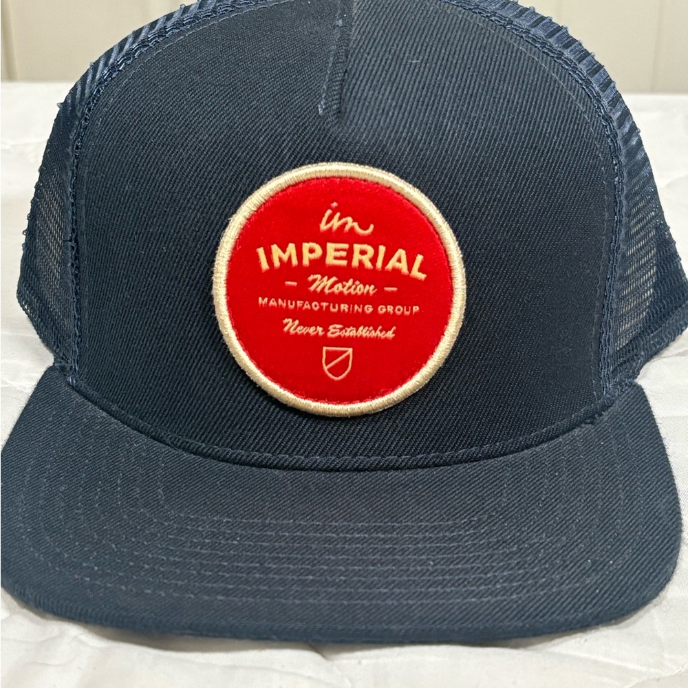 Imperial Motion Dark Blue Trucker Hat with Red Patch